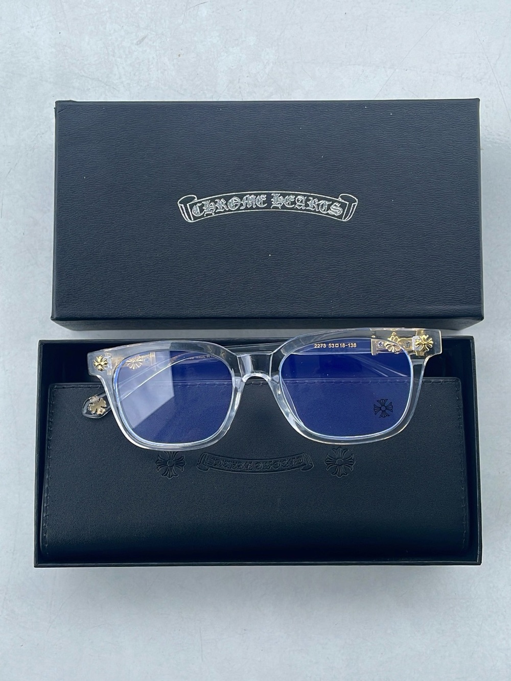 Chrome Hearts Clear Frame Sunglasses with Blue Lenses and Gold Accents